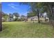 The spacious backyard features a large grassy area and mature trees at 2703 Phyllis St, North Charleston, SC 29405