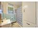 A retro-style bathroom featuring light blue tiling and a window at 2703 Phyllis St, North Charleston, SC 29405