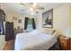 Bright bedroom features a ceiling fan, vintage hardwood floors, and a large bed at 2703 Phyllis St, North Charleston, SC 29405
