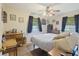 This bedroom features a ceiling fan, two windows, and classic hardwood floors at 2703 Phyllis St, North Charleston, SC 29405