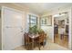 Bright dining area with a wooden table and chairs, filled with potted plants by the window at 2703 Phyllis St, North Charleston, SC 29405