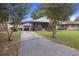 Charming brick home with covered parking, a well-kept lawn, and mature trees at 2703 Phyllis St, North Charleston, SC 29405