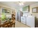 Kitchen with stainless steel refrigerator, white appliances, and a dining table, connecting to the living space at 2703 Phyllis St, North Charleston, SC 29405