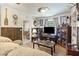 Living room with a tan sofa, TV and lots of wall decorations at 2703 Phyllis St, North Charleston, SC 29405