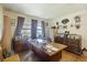 Large office with a sizable wooden desk, hardwood floors, and vintage decor creating a workspace at 2703 Phyllis St, North Charleston, SC 29405