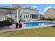 Beautiful backyard with an in-ground pool, covered patio, and lush lawn, perfect for outdoor enjoyment at 2917 River Vista Way, Mount Pleasant, SC 29466