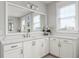 Bright bathroom featuring white cabinets, a large mirror, a window, and light countertops at 2917 River Vista Way, Mount Pleasant, SC 29466