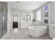 Bathroom featuring a soaking tub, white cabinets, a large mirror and windows to bring in natural light at 2917 River Vista Way, Mount Pleasant, SC 29466