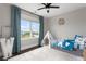 Charming bedroom with light blue accents, a bed, and natural light streaming through the large window at 2917 River Vista Way, Mount Pleasant, SC 29466