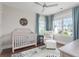 Cozy Bedroom featuring a crib, a comfy chair with ottoman, and a view from the bright window at 2917 River Vista Way, Mount Pleasant, SC 29466