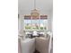 Intimate breakfast nook featuring a glass table, upholstered chairs, and scenic views through large windows at 2917 River Vista Way, Mount Pleasant, SC 29466
