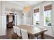 Bright dining room showcasing a decorative chandelier, farmhouse table with seating for six, and stylish lighting at 2917 River Vista Way, Mount Pleasant, SC 29466