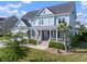 Charming two-story home with a welcoming front porch, landscaping and mature trees at 2917 River Vista Way, Mount Pleasant, SC 29466