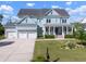 Charming two-story home with a welcoming front porch, three car garage and a nicely manicured front yard at 2917 River Vista Way, Mount Pleasant, SC 29466