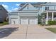 Attached three car garage with white doors and a long driveway at 2917 River Vista Way, Mount Pleasant, SC 29466