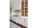 Bright kitchen featuring a marble countertop, gold fixtures and hardware, and glass door cabinets displaying dishware at 2917 River Vista Way, Mount Pleasant, SC 29466