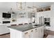 Open concept kitchen and living room featuring a large island with bar seating at 2917 River Vista Way, Mount Pleasant, SC 29466