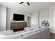Inviting living room with gray sectional sofa, wood floors, and a wooden cabinet beneath the television at 2917 River Vista Way, Mount Pleasant, SC 29466