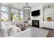 Inviting living room featuring a fireplace, large TV, and a large comfortable sectional sofa at 2917 River Vista Way, Mount Pleasant, SC 29466