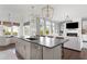 Open concept kitchen and living room featuring an island with seating and a fireplace at 2917 River Vista Way, Mount Pleasant, SC 29466