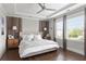Spacious bedroom with hardwood flooring, ceiling fan, two windows providing natural light, and side tables at 2917 River Vista Way, Mount Pleasant, SC 29466