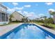 Inviting in-ground pool with stamped concrete surround, and two lounge chairs providing the perfect backyard oasis at 2917 River Vista Way, Mount Pleasant, SC 29466