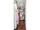 Walk-in closet featuring hardwood floors, custom shelving, ample storage, and a modern chandelier at 2917 River Vista Way, Mount Pleasant, SC 29466