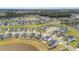 Gorgeous aerial view of a home in a well-planned community, complete with ponds, tree lines, and sidewalks at 302 Lucca Dr, Summerville, SC 29486
