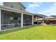 Spacious covered patio with comfortable seating, a fireplace, a hot tub, and an outdoor kitchen at 302 Lucca Dr, Summerville, SC 29486