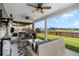 Relaxing screened-in back porch with outdoor furniture, ceiling fans, and serene backyard views at 302 Lucca Dr, Summerville, SC 29486