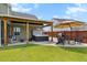 Expansive backyard with a hot tub, covered patio, lush lawn, and a seating area for outdoor relaxation at 302 Lucca Dr, Summerville, SC 29486