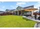 Spacious backyard with a hot tub, patio seating, lush green lawn, and plenty of room for activities at 302 Lucca Dr, Summerville, SC 29486