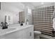 Bright bathroom with double vanity, modern fixtures, and stylish shower curtain at 302 Lucca Dr, Summerville, SC 29486