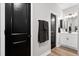 Bright and modern bathroom featuring black door accents, white cabinets, and stylish light fixtures at 302 Lucca Dr, Summerville, SC 29486