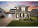 Charming two-story home with a well-manicured lawn, covered porch, and attached two-car garage at 302 Lucca Dr, Summerville, SC 29486