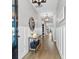 Inviting hallway with modern decor, light walls, wood flooring, and decorative lighting fixtures at 302 Lucca Dr, Summerville, SC 29486