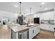 Open-concept kitchen with a large island, stainless steel appliances, and seamless flow into the living area at 302 Lucca Dr, Summerville, SC 29486