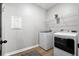 Bright laundry room with modern washer and dryer, wire shelving, and wood-look flooring at 302 Lucca Dr, Summerville, SC 29486