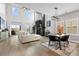 Bright, open-concept living room featuring a fireplace, dining area, and access to the outdoor deck at 302 Lucca Dr, Summerville, SC 29486