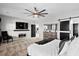Bright main bedroom with a dark accent wall, barn door, large TV, and contemporary decor at 302 Lucca Dr, Summerville, SC 29486