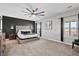 Stylish main bedroom with a tufted headboard, modern ceiling fan, and natural light at 302 Lucca Dr, Summerville, SC 29486