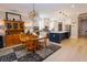 Spacious dining room with modern lighting fixture, hardwood floors, and kitchen view at 3025 Rampart Rd, Summerville, SC 29483
