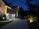 Driveway and home exterior at dusk, accented with landscape lighting at 3025 Rampart Rd, Summerville, SC 29483