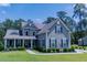 Charming two-story home with a landscaped front yard and inviting covered porch at 3025 Rampart Rd, Summerville, SC 29483