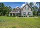 Inviting two-story home with a well-manicured lawn and mature trees at 3025 Rampart Rd, Summerville, SC 29483