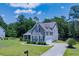 Well-maintained two-story home with manicured lawn, beautiful landscaping, and attached two-car garage at 3025 Rampart Rd, Summerville, SC 29483