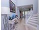 Inviting foyer with hardwood floors, elegant decor, and staircase at 3025 Rampart Rd, Summerville, SC 29483