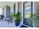 Inviting covered front porch with comfortable seating and view of a manicured yard at 3025 Rampart Rd, Summerville, SC 29483