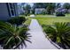 Beautifully landscaped front yard with a concrete walkway leading to a lovely home at 3025 Rampart Rd, Summerville, SC 29483
