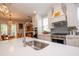 Modern kitchen with stainless steel sink, white cabinets, and view to dining area at 3025 Rampart Rd, Summerville, SC 29483